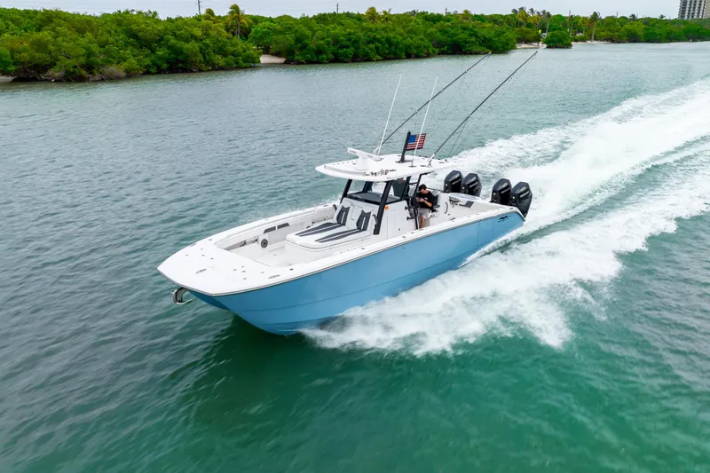 Kroppdustr Yacht Photos Pics 2023 Invincible 37 Catamaran cruising on a scenic waterway with lush greenery.
