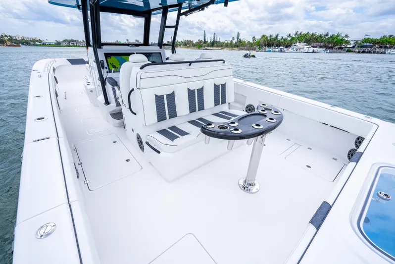 Kroppdustr Yacht Photos Pics 2023 Invincible 37 Catamaran interior with seating and table on calm water.