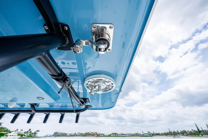 Kroppdustr Yacht Photos Pics 2023 Invincible 37 Catamaran detail with blue hull and hardware against cloudy sky.