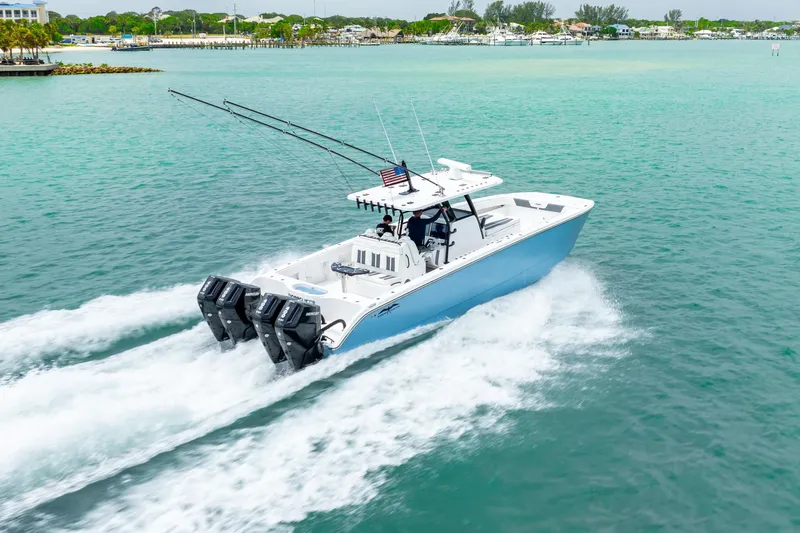 Kroppdustr Yacht Photos Pics 2023 Invincible 37 Catamaran cruising on turquoise waters, showcasing powerful engines.