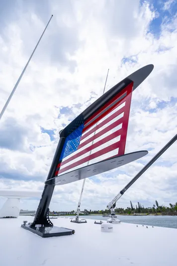 Kroppdustr Yacht Photos Pics American flag on 2023 Invincible 37 Catamaran against cloudy sky.