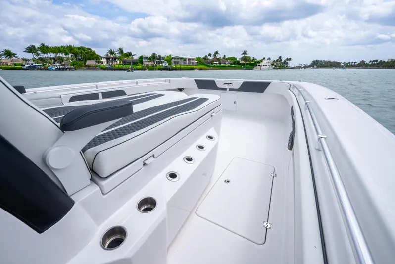 Kroppdustr Yacht Photos Pics 2023 Invincible 37 Catamaran interior with seating, cup holders, and ocean view.