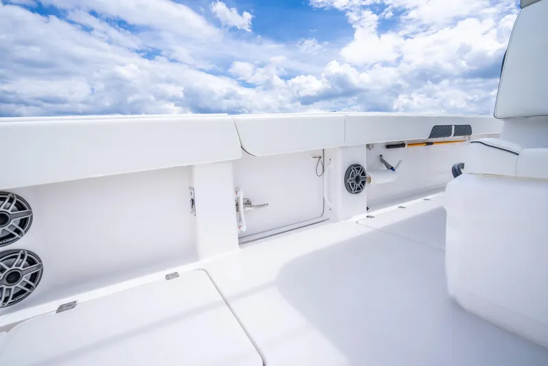 Kroppdustr Yacht Photos Pics 2023 Invincible 37 Catamaran interior with speakers and storage, under a bright blue sky.