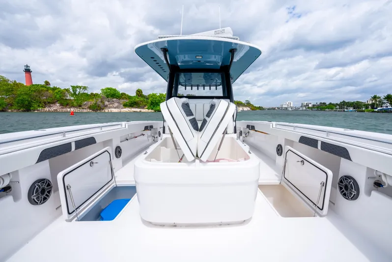 Kroppdustr Yacht Photos Pics 2023 Invincible 37 Catamaran on water, showcasing spacious deck and storage compartments.