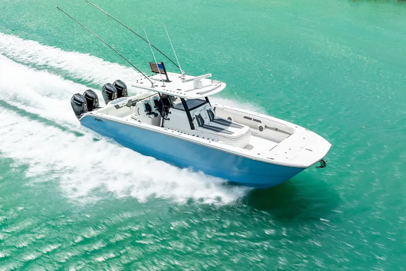 Kroppdustr Yacht Photos Pics 2023 Invincible 37 Catamaran cruising on turquoise water, showcasing sleek design and powerful engines.