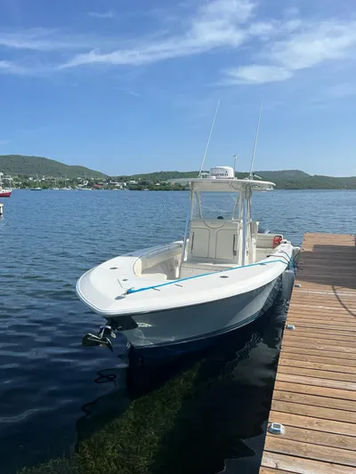  Yacht Photos Pics 2013 Contender 30 ST boat docked on calm water under a clear blue sky.