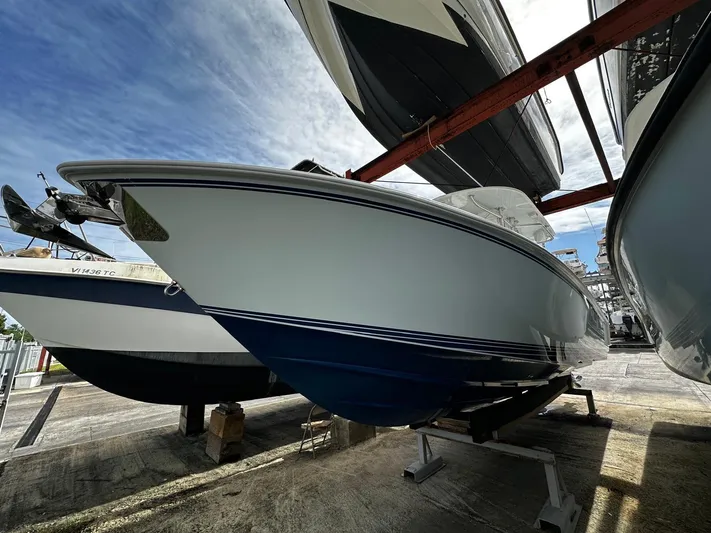  Yacht Photos Pics 2013 Contender 30 ST boat on dry dock, viewed from the side.