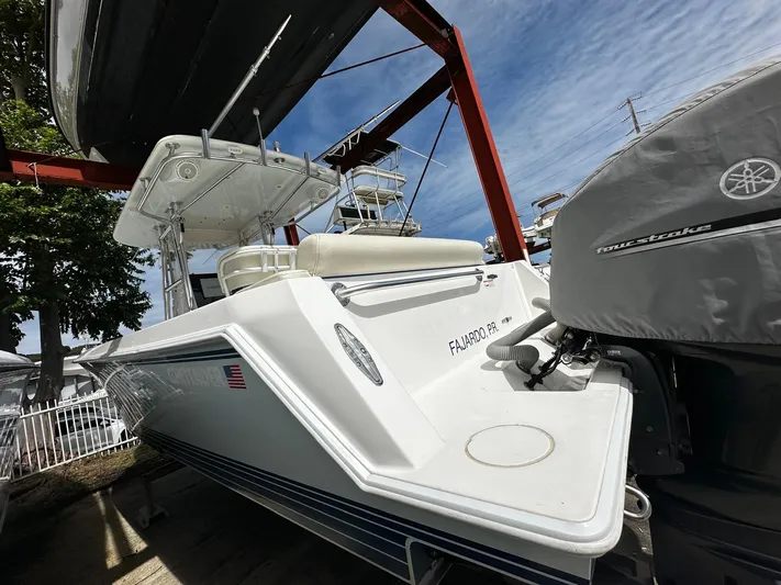  Yacht Photos Pics 2013 Contender 30 ST boat with Yamaha outboard motor, docked under a blue sky.