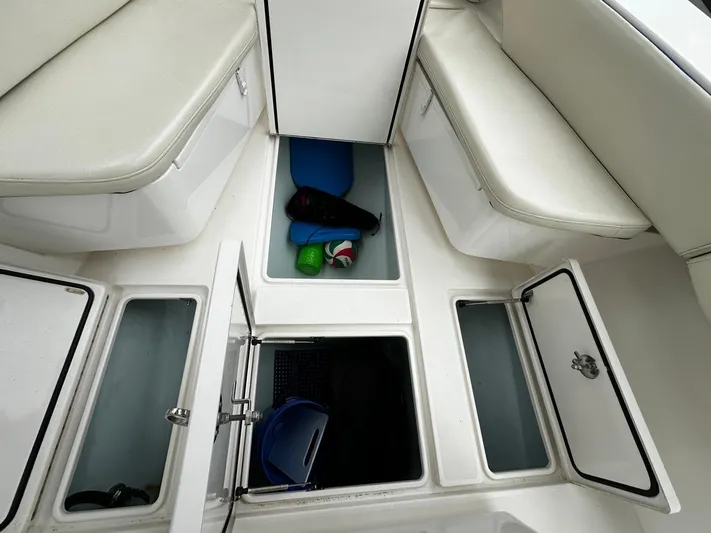  Yacht Photos Pics 2013 Contender 30 ST boat interior with open storage compartments and seating.