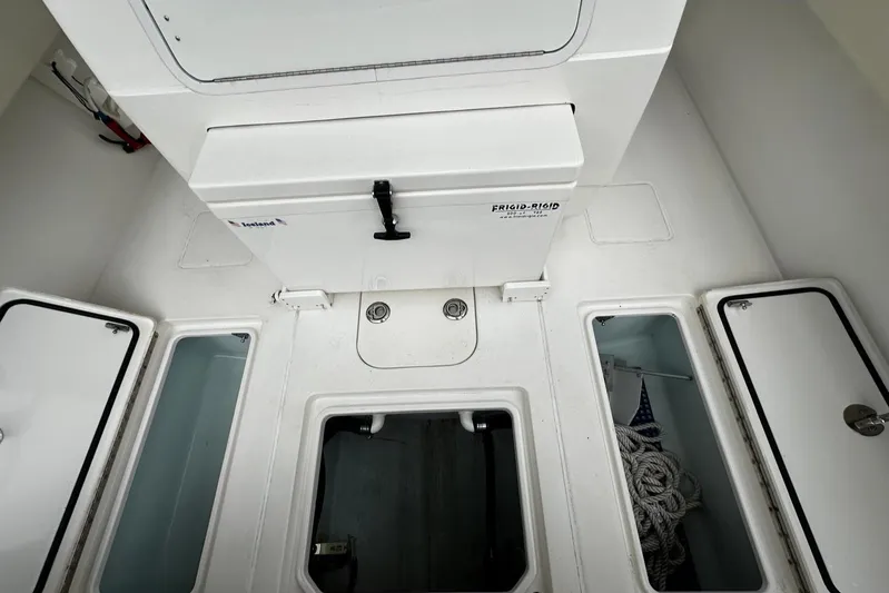  Yacht Photos Pics 2013 Contender 30 ST boat storage compartments and hatches, interior view.