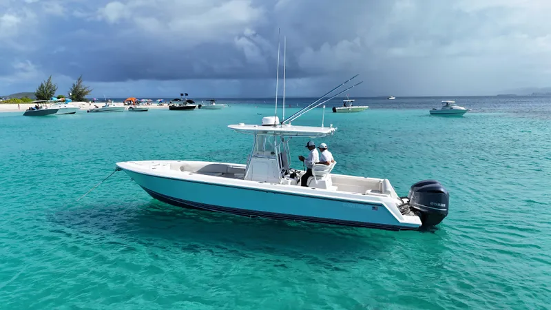  Yacht Photos Pics 2013 Contender 30 ST boat on turquoise water near a sandy beach with other boats.
