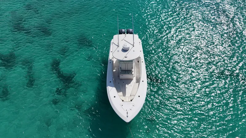  Yacht Photos Pics Aerial view of 2013 Contender 30 ST boat on clear turquoise water.