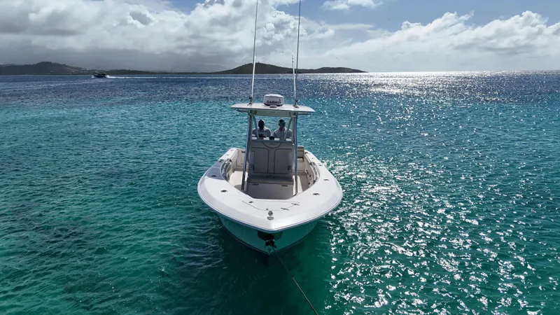  Yacht Photos Pics 2013 Contender 30 ST boat on clear turquoise water under a sunny sky.