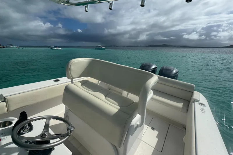  Yacht Photos Pics 2013 Contender 30 ST boat on turquoise water under cloudy sky.