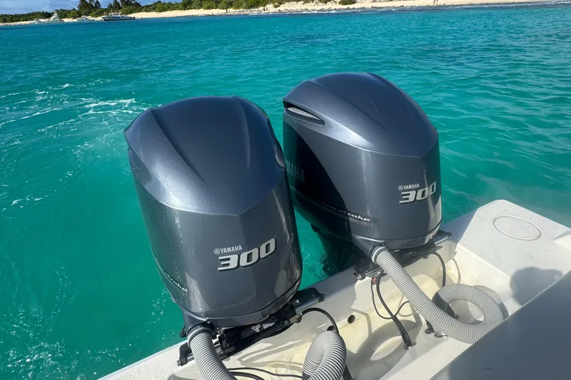  Yacht Photos Pics Twin Yamaha 300 outboard motors on a 2013 Contender 30 ST in clear blue water.