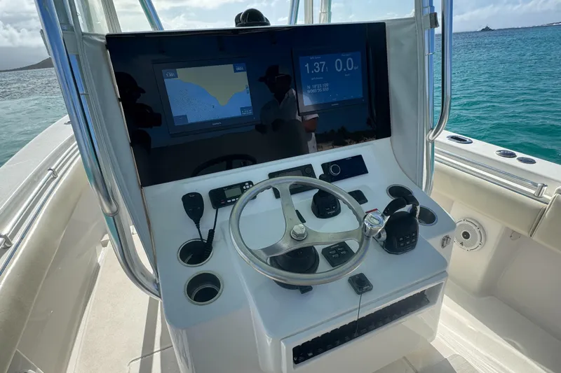  Yacht Photos Pics 2013 Contender 30 ST boat helm with navigation screens and steering wheel.