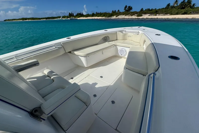  Yacht Photos Pics 2013 Contender 30 ST boat interior with white seating, near tropical shoreline.