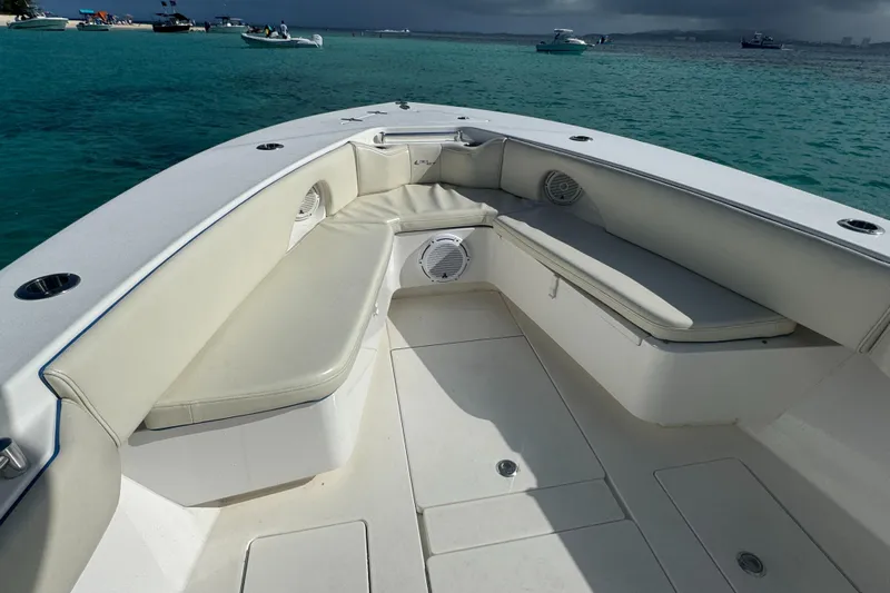  Yacht Photos Pics 2013 Contender 30 ST boat interior with cushioned seating, on clear turquoise water.