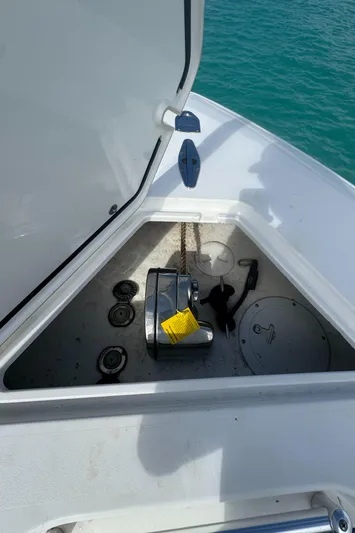  Yacht Photos Pics Anchor compartment of 2013 Contender 30 ST boat with open hatch, showing anchor and rope.