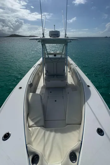  Yacht Photos Pics 2013 Contender 30 ST boat on calm turquoise water under cloudy sky.