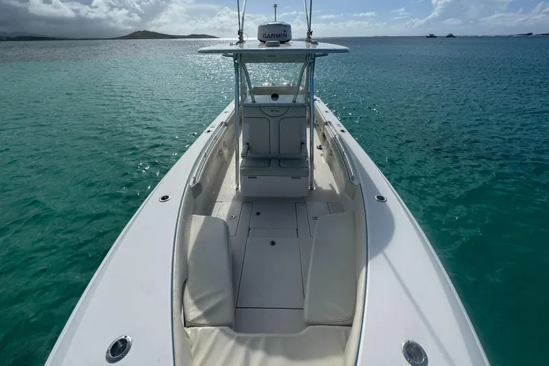  Yacht Photos Pics 2013 Contender 30 ST boat on clear turquoise water, featuring a spacious deck and Garmin equipment.