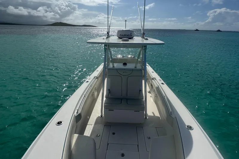  Yacht Photos Pics 2013 Contender 30 ST boat on clear turquoise water under a sunny sky.