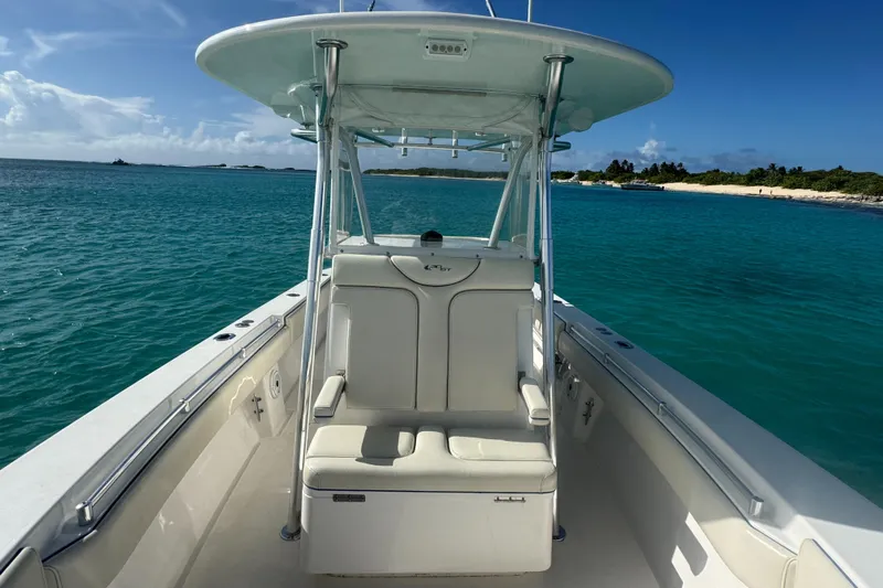  Yacht Photos Pics 2013 Contender 30 ST boat on clear blue water near a sandy beach.
