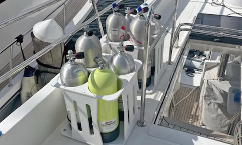 Our Way III Yacht Photos Pics 2023 Outer Reef Yachts 720 Motoryacht deck with scuba tanks and safety railing.