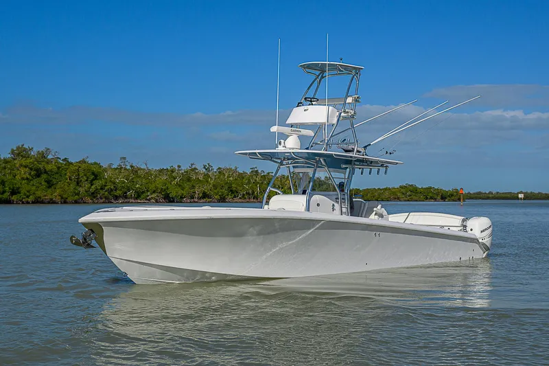 Mare Yacht Photos Pics 2019 Bahama 41 boat on calm water under clear blue sky.