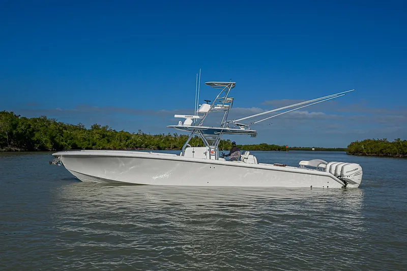 Mare Yacht Photos Pics 2019 Bahama 41 boat on calm water under clear blue sky.
