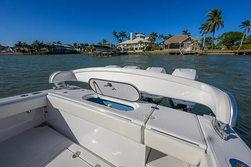 Mare Yacht Photos Pics 2019 Bahama 41 boat with open deck, scenic waterfront view, and palm trees in the background.
