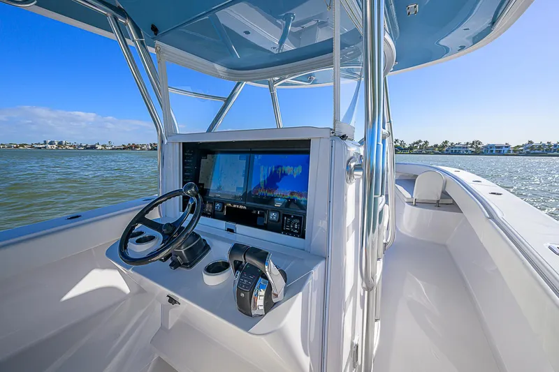 Mare Yacht Photos Pics 2019 Bahama 41 boat cockpit with advanced navigation system and steering wheel on open water.