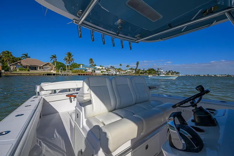 Mare Yacht Photos Pics 2019 Bahama 41 boat interior with white seating, steering console, and scenic waterfront view.
