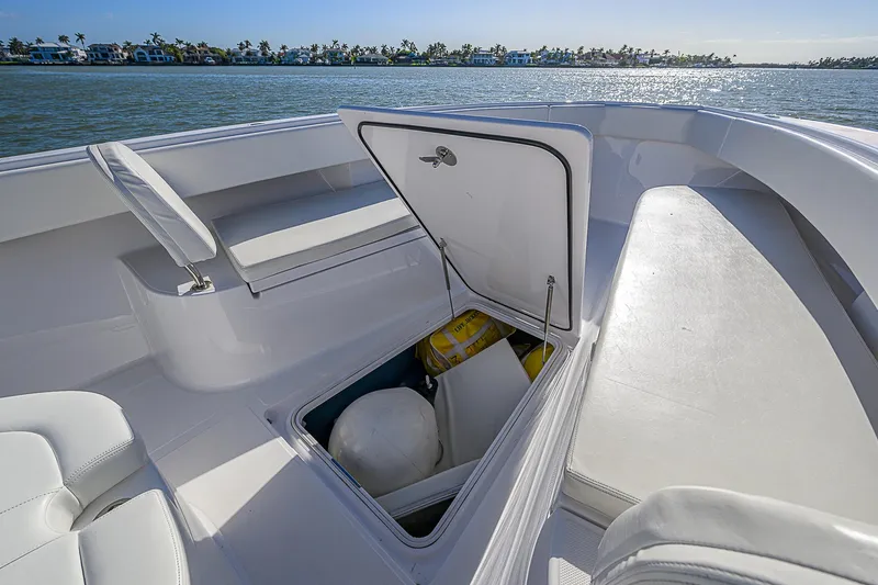 Mare Yacht Photos Pics 2019 Bahama 41 boat with open storage compartment on deck, near water.