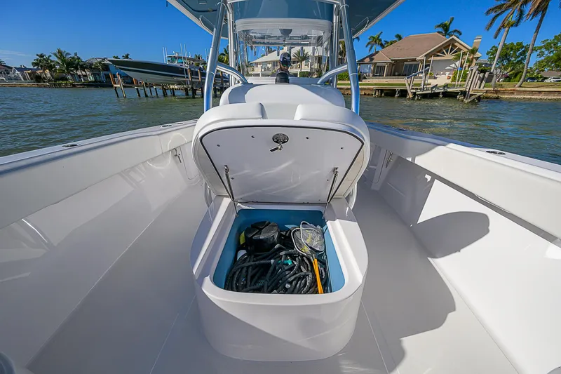 Mare Yacht Photos Pics 2019 Bahama 41 boat with open storage compartment, docked near waterfront homes.