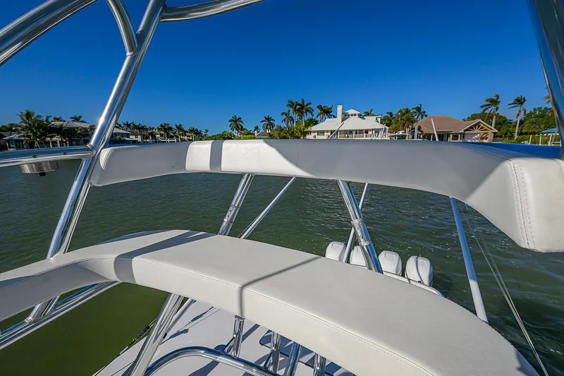 Mare Yacht Photos Pics 2019 Bahama 41 boat with sleek seating, overlooking waterfront homes and palm trees.