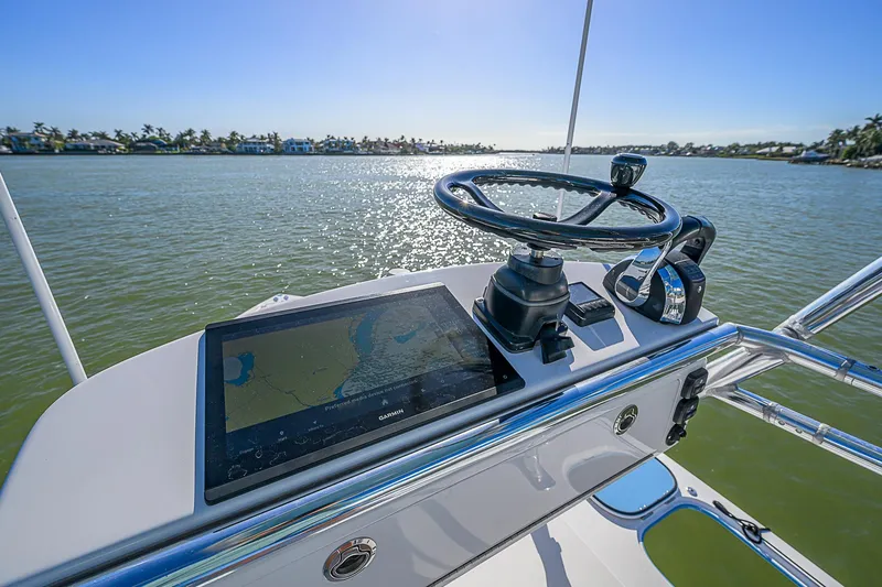 Mare Yacht Photos Pics Control panel of a 2019 Bahama 41 boat with steering wheel and navigation screen.