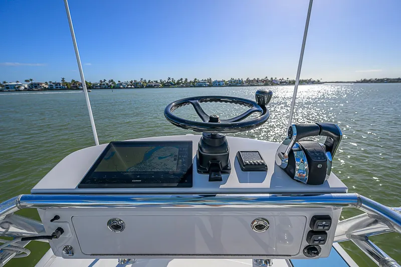 Mare Yacht Photos Pics Control panel of a 2019 Bahama 41 boat with steering wheel and navigation equipment.
