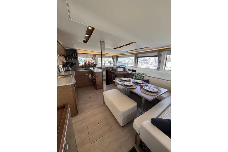  Yacht Photos Pics Luxurious interior of 2020 Lagoon 46 yacht with dining area and modern kitchen.