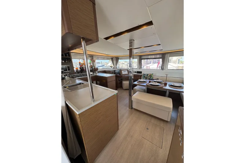  Yacht Photos Pics Interior of 2020 Lagoon 46 catamaran with modern kitchen and dining area.