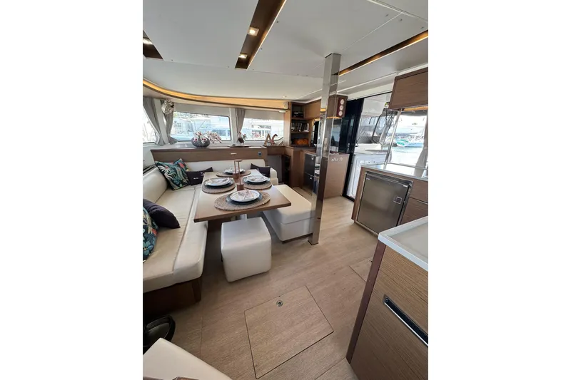  Yacht Photos Pics Luxurious interior of 2020 Lagoon 46 catamaran with elegant dining area and modern kitchen.