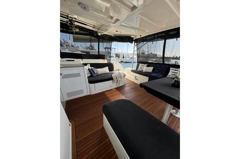  Yacht Photos Pics Interior of 2020 Lagoon 46 catamaran with wooden flooring and comfortable seating.
