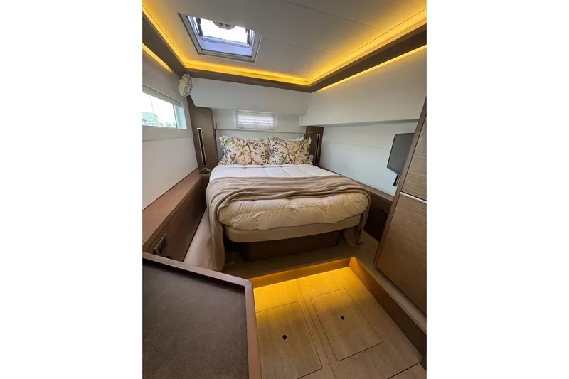  Yacht Photos Pics Luxurious cabin interior of 2020 Lagoon 46 yacht with cozy bed and ambient lighting.