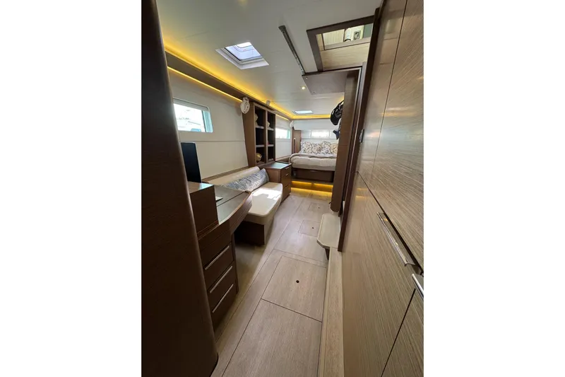  Yacht Photos Pics Luxurious interior of 2020 Lagoon 46 yacht with modern wood finish and ambient lighting.