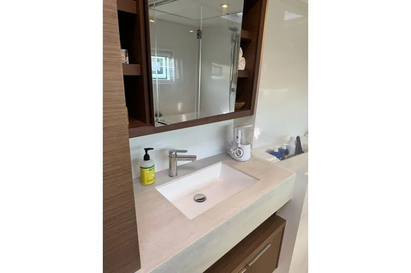  Yacht Photos Pics Modern bathroom sink in 2020 Lagoon 46 yacht, featuring sleek design and wooden accents.