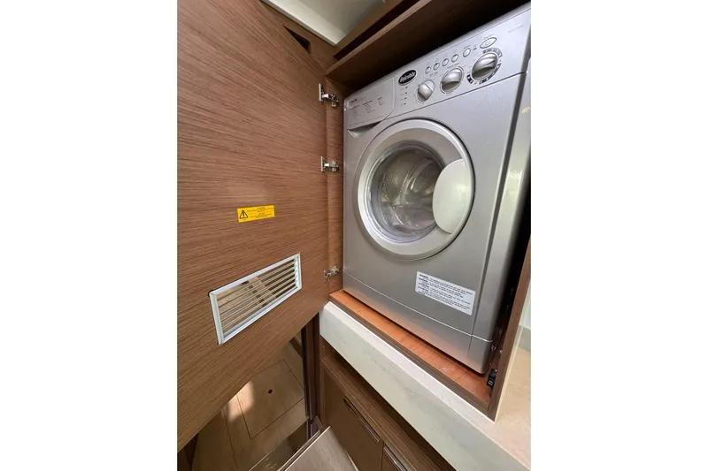  Yacht Photos Pics Washing machine inside a 2020 Lagoon 46 yacht's wooden cabinet.
