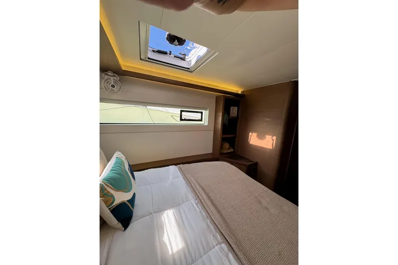  Yacht Photos Pics Luxurious cabin interior of 2020 Lagoon 46 catamaran with skylight and cozy bedding.