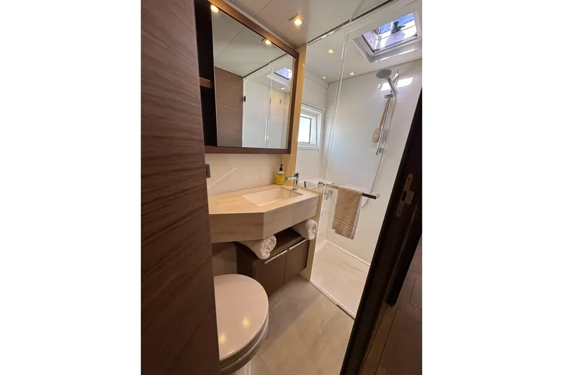  Yacht Photos Pics Modern bathroom in 2020 Lagoon 46 yacht with shower, sink, and skylight.