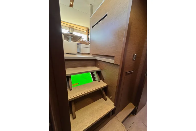  Yacht Photos Pics Interior stairs of 2020 Lagoon 46 yacht, featuring modern wooden design.