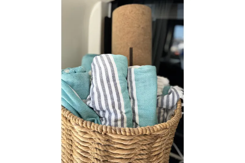  Yacht Photos Pics Woven basket with striped and teal towels on Lagoon 46 yacht, 2020 model.